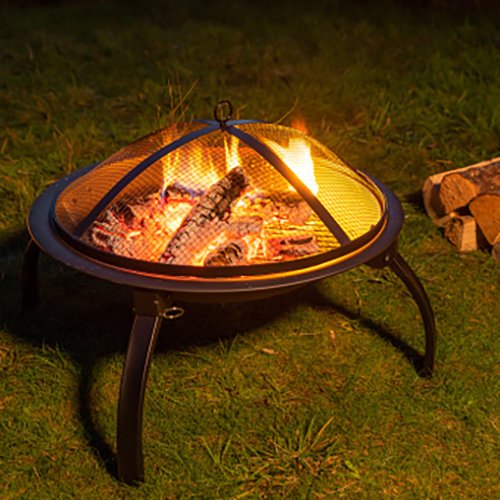 Fire pit in a garden with spare logs