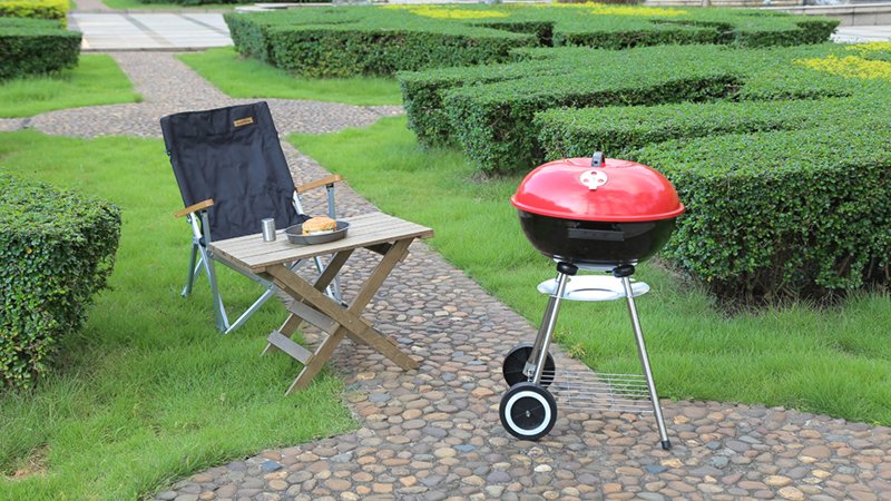 charcoal kettle grill in red and black