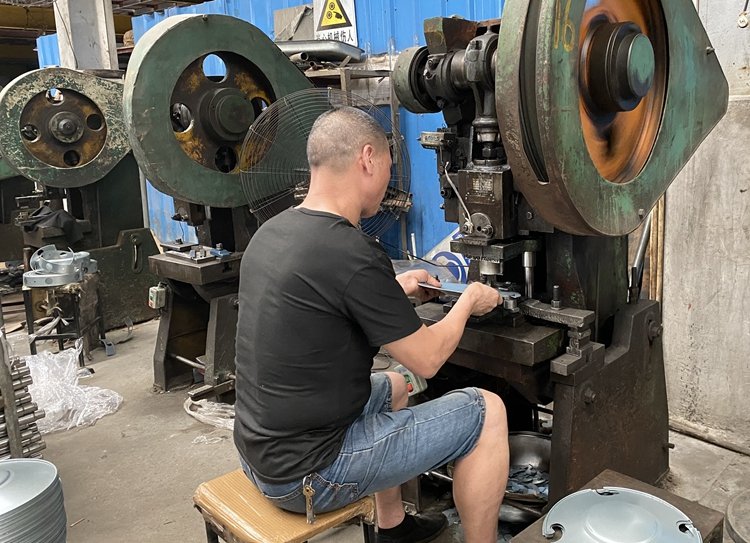 Punching the holes in charcoal grill factory